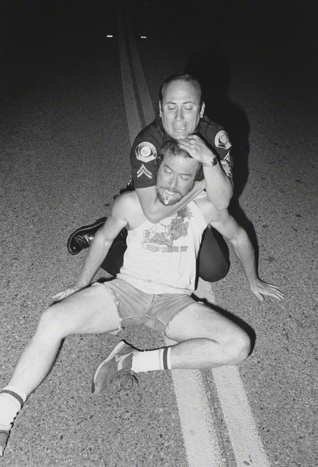 6/7/86 Agent Baroni applying carotid hold to suspect under the influence of PCP who attacked our police car. (note that the suspect's T-shirt says "I passed the Breath Test"). Melrose Avenue and Avenue 64.