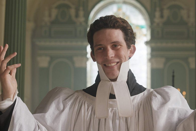 Josh O'Connor wears a high-necked frock and holds one hand outstretched.