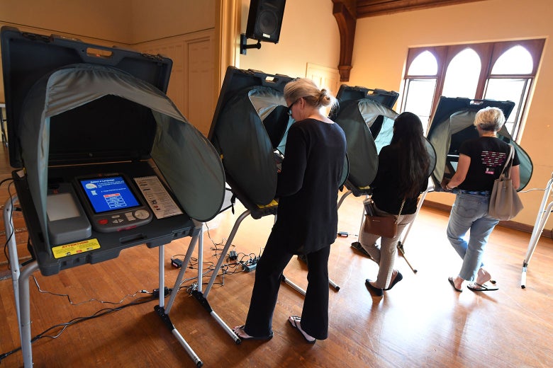 People use electronic voting machines to cast their ballots.