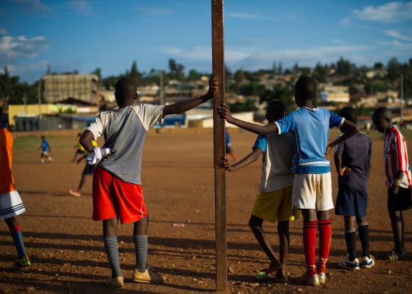 Rwandans take a break during a youth soccer game in the Gikondo suburb of Kigali on March 16, 2014.