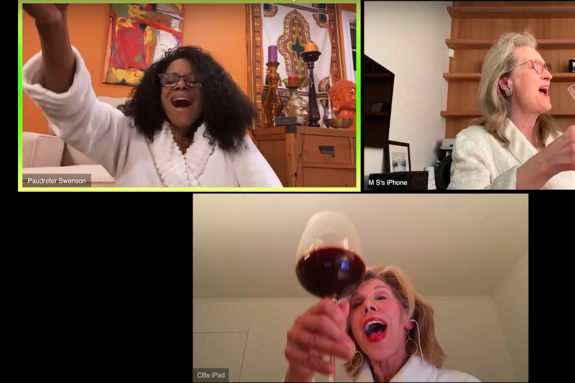 Audra McDonald, Meryl Streep, and Christine Baranski on three separate video chat screens, wearing bathrobes and holding up glasses of alcohol while singing