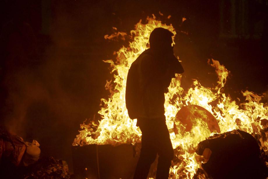 Supporters of opposition leader Leopoldo Lopez light fires on Feb. 18, 2014, in Caracas.