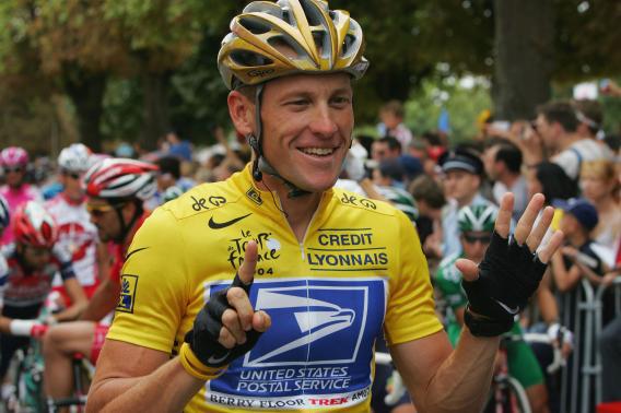 Lance Armstrong riding for the U.S. Postal Service team shows six fingers representing his six consecutive Tour de France victories