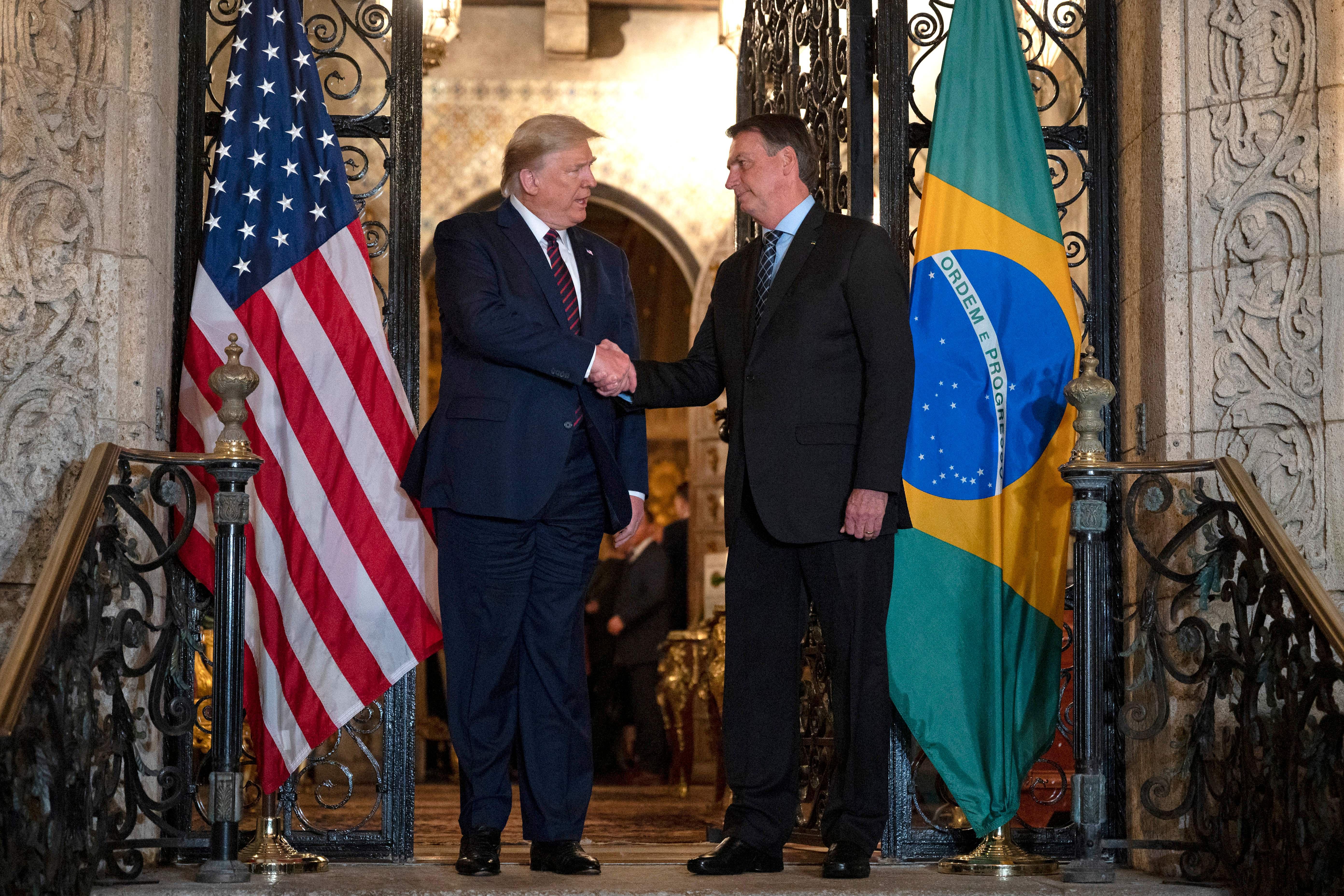 President Trump shakes hands with Brazilian President Jair Bolsonaro earlier this month at Mar-a-Lago.