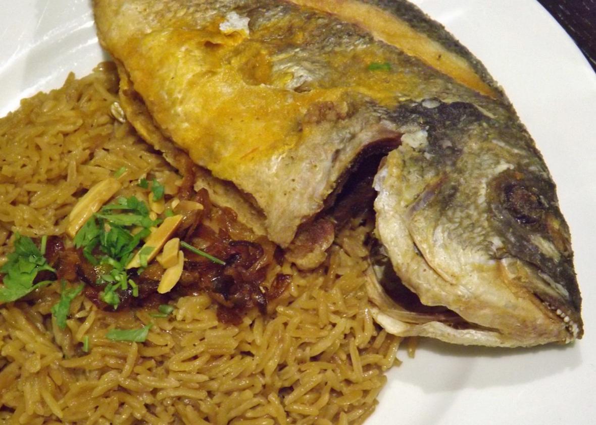 Sayadieh, a Syrian fish dish with spiced rice and caramelized onions.