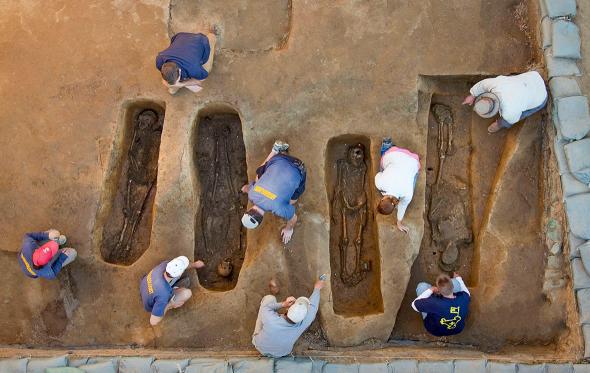 Overview of the chancel burial excavations. Archaeologists (from left to right) Mary Anna Richardson, Danny Schmidt, David Givens, Dan Smith, Don Warmke, Jamie May, Dan Gamble, and Dr. William Kelso. 