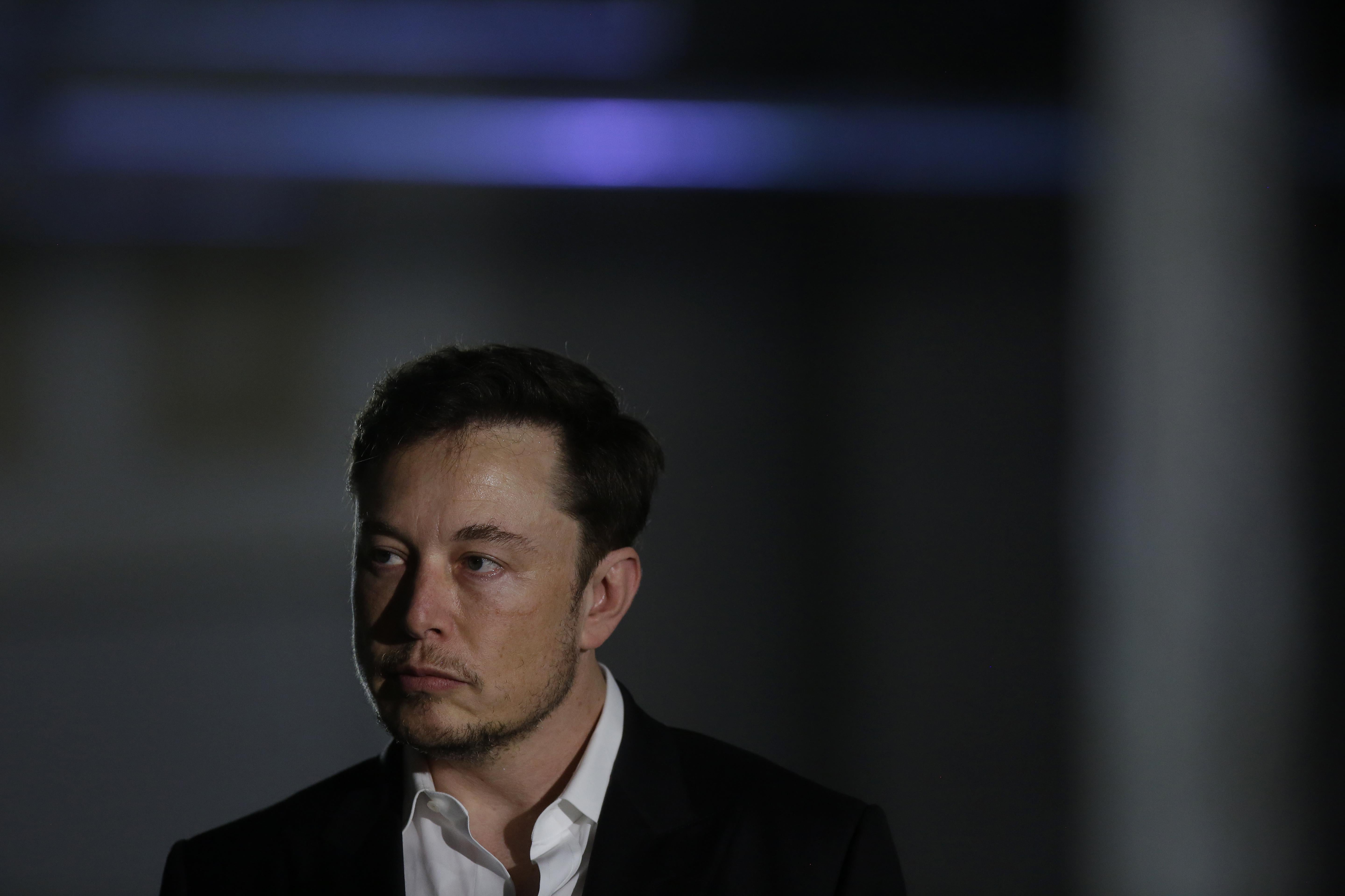 Elon Musk listens as Chicago Mayor Rahm Emanuel talks about constructing a high speed transit tunnel on June 14, 2018 in Chicago Illinois.