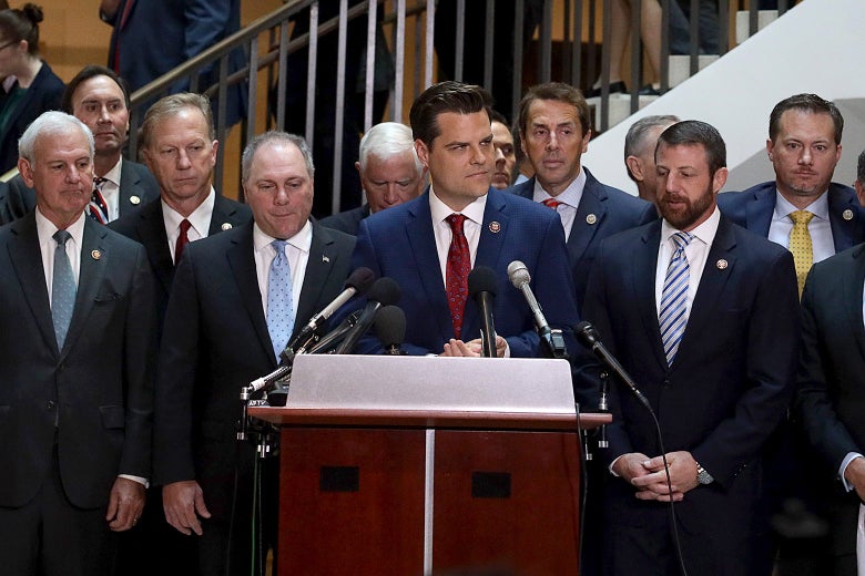 Flanked by about two dozen House Republicans, Matt Gaetz speaks during a press conference at the U.S. Capitol on Wednesday.