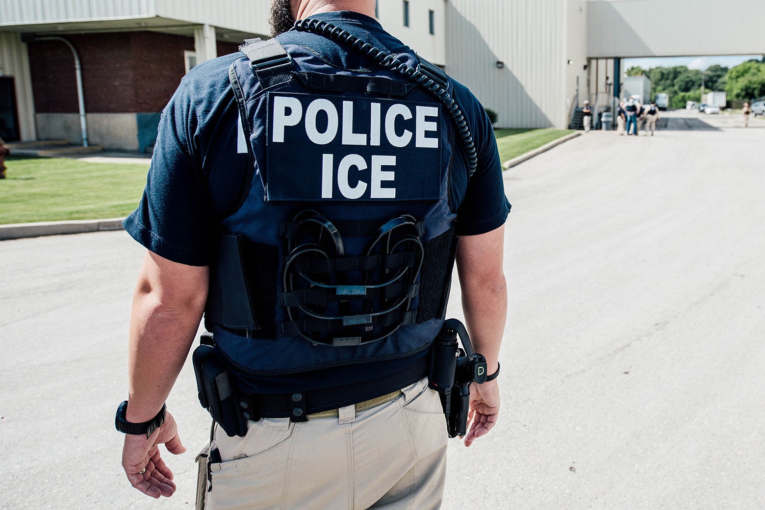 An Immigration and Customs Enforcement special agent prepares to arrest alleged immigration violators at Fresh Mark in Salem, Ohio on June 19.