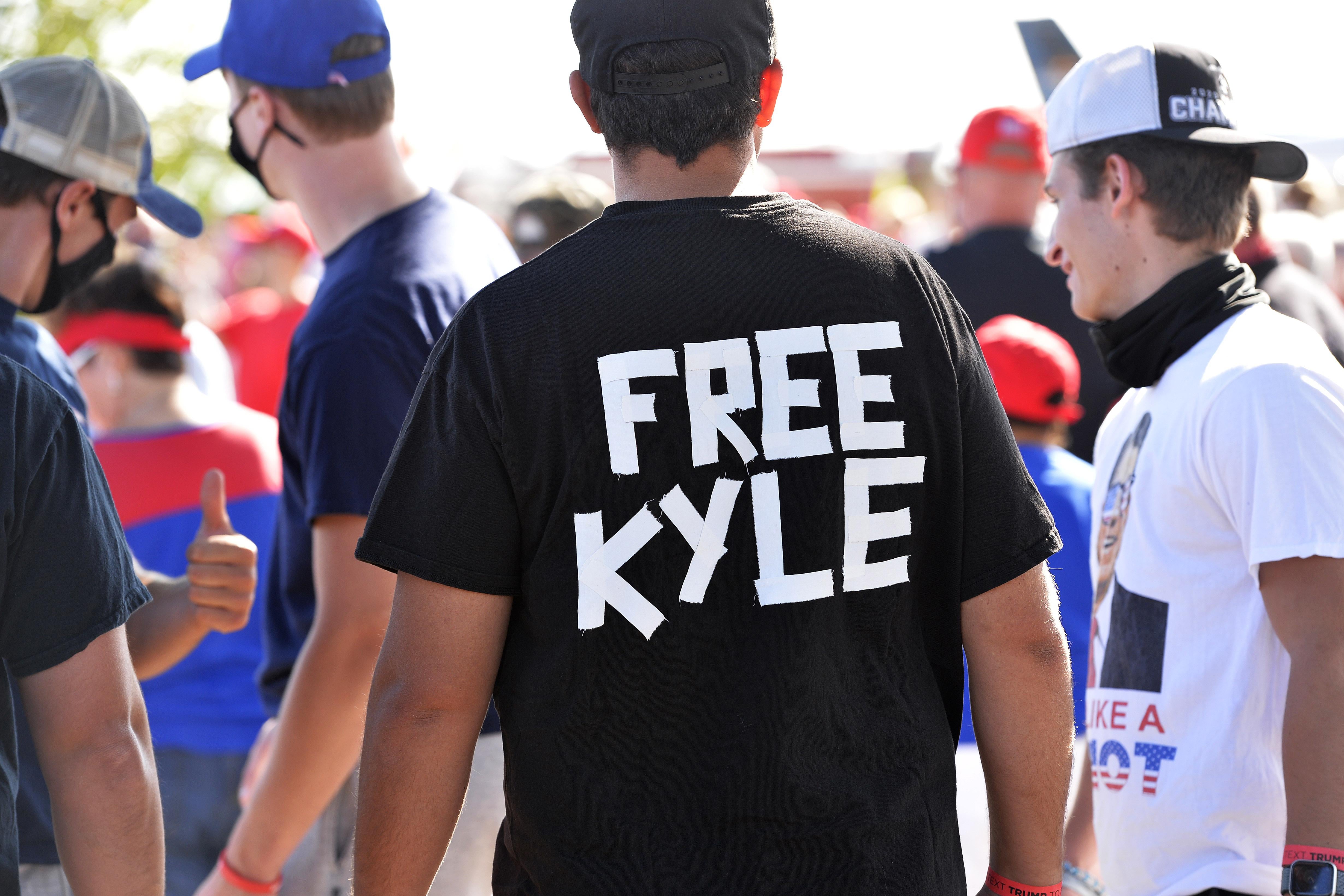 A man wears a shirt calling for freedom for Kyle Rittenhouse, 17, the man who allegedly shot protesters in Wisconsin, during a President Donald Trump campaign rally at Manchester airport in Londonderry, New Hampshire on August 28, 2020. 