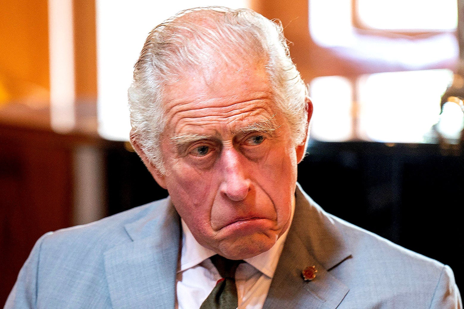 Britain's Prince Charles, now King Charles, with a somber look on his face.