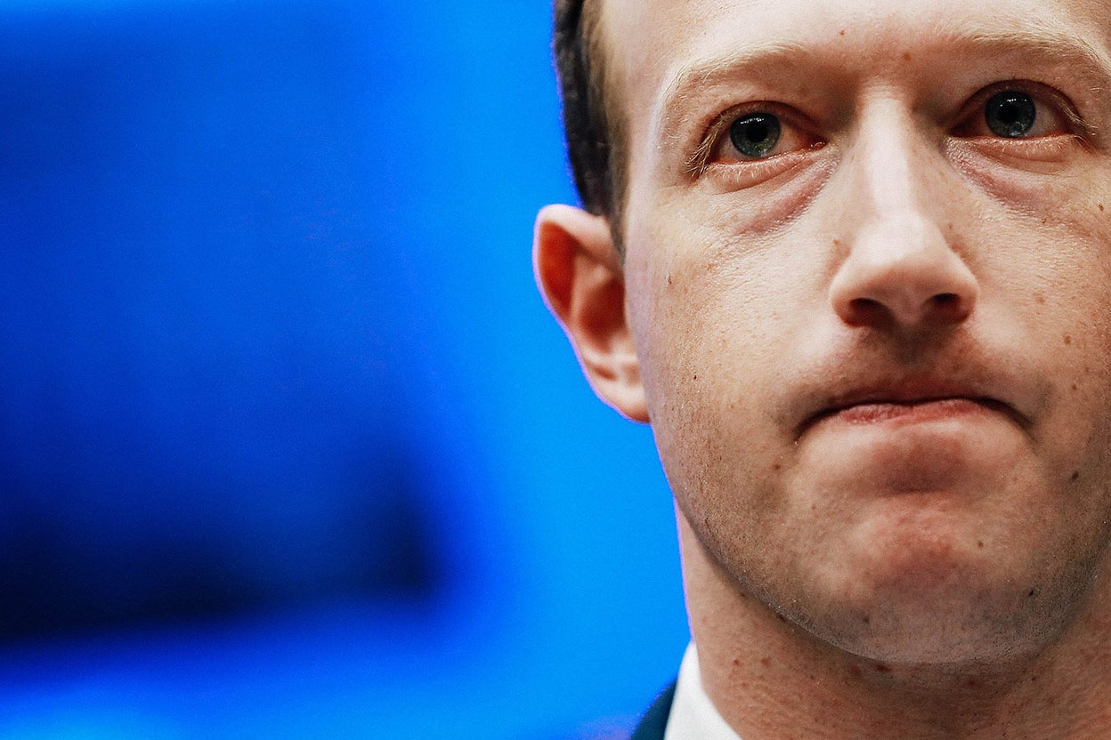 Close-up of Facebook CEO Mark Zuckerberg looking sheepish while testifying before Congress.