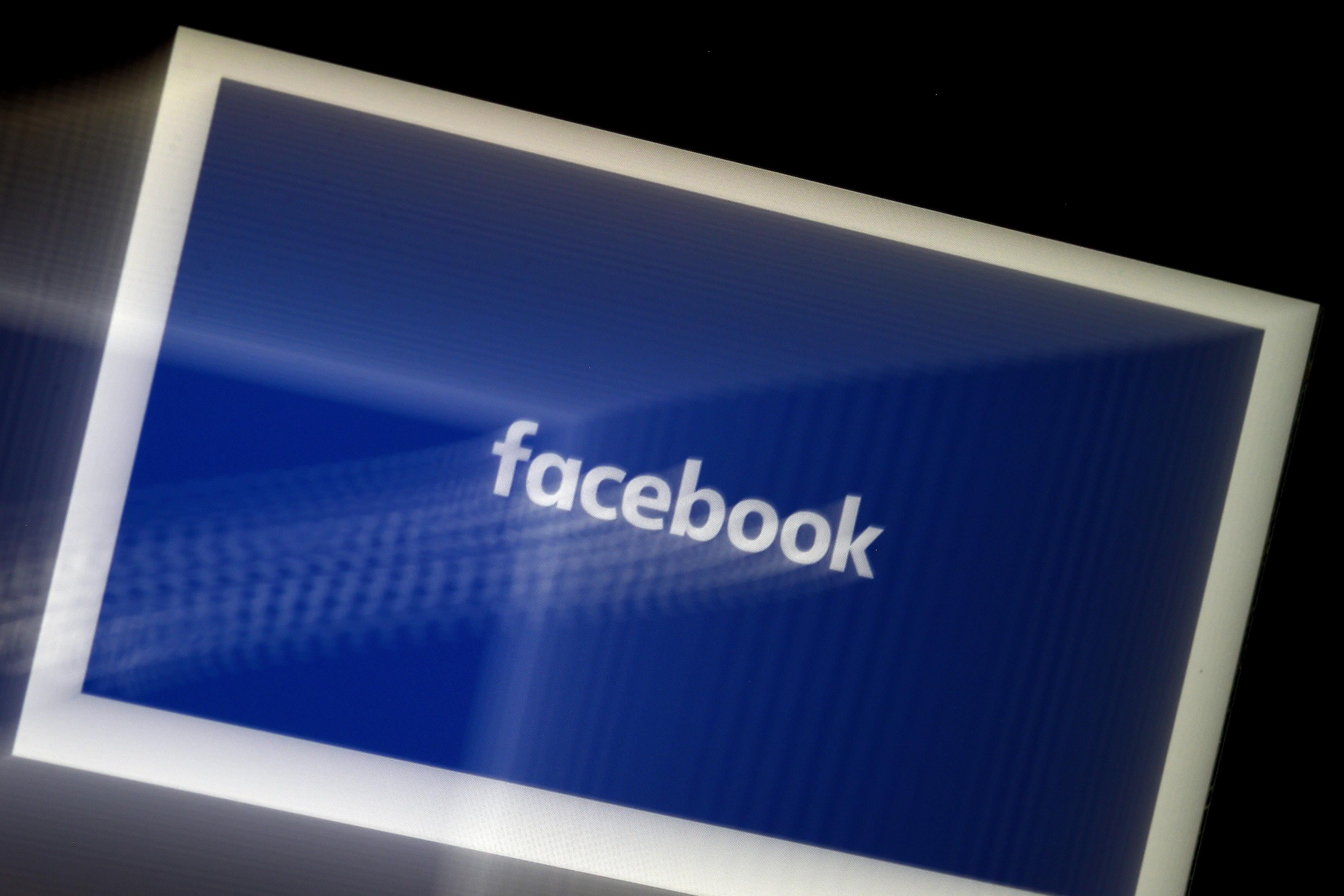 A blurred image of the Facebook logo on a tablet