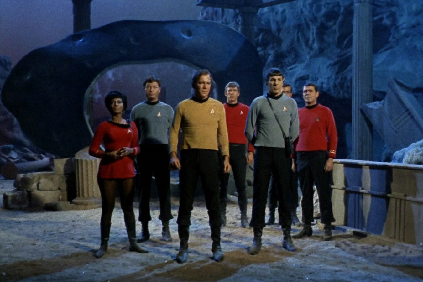 The original cast of Star Trek, in red, teal, and yellow uniforms.