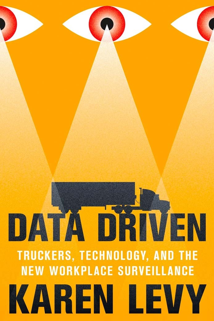 A book cover shows an eye beaming down on a truck.