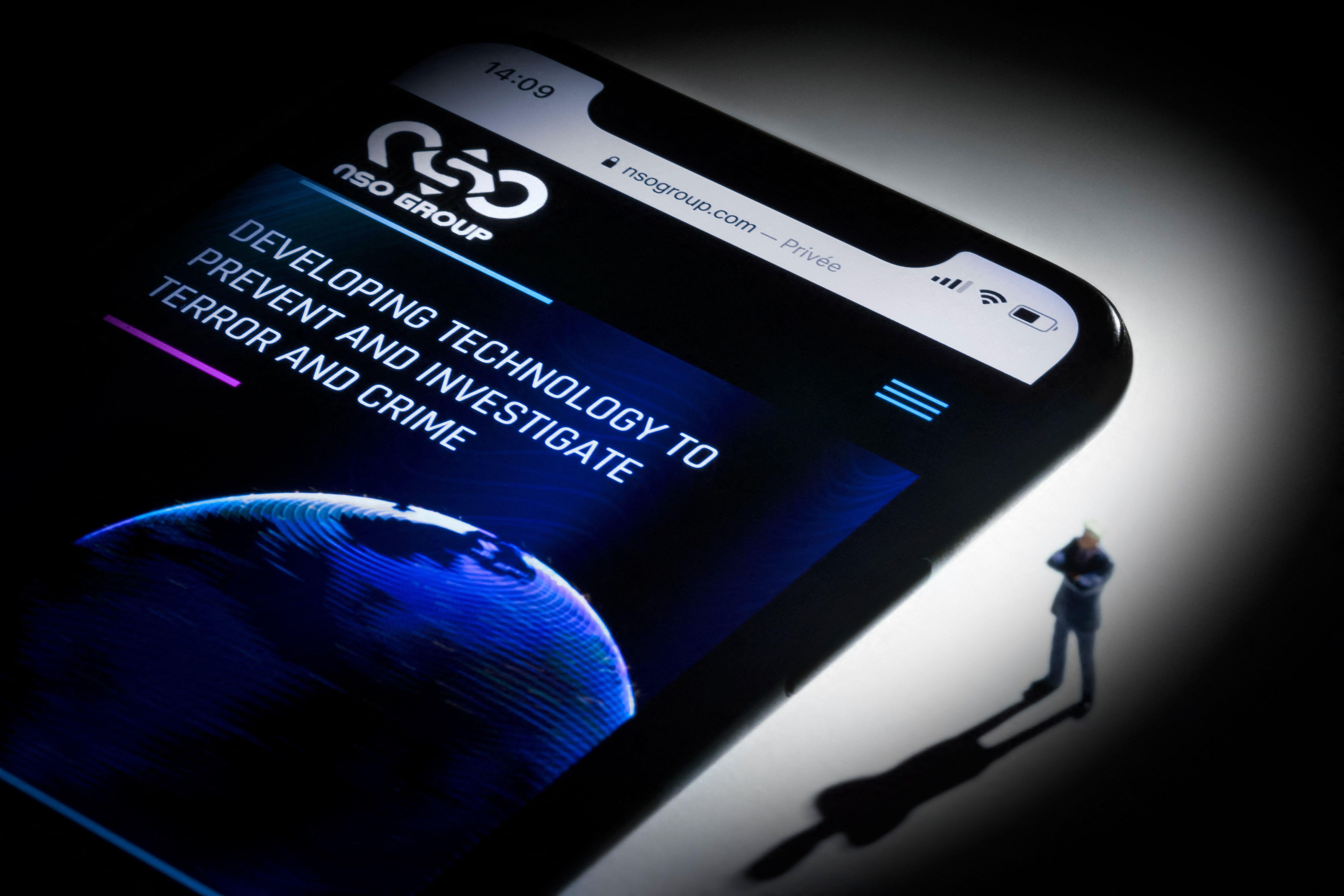 This studio photographic illustration shows a smartphone with the website of Israel's NSO Group which features 'Pegasus' spyware, on display. 