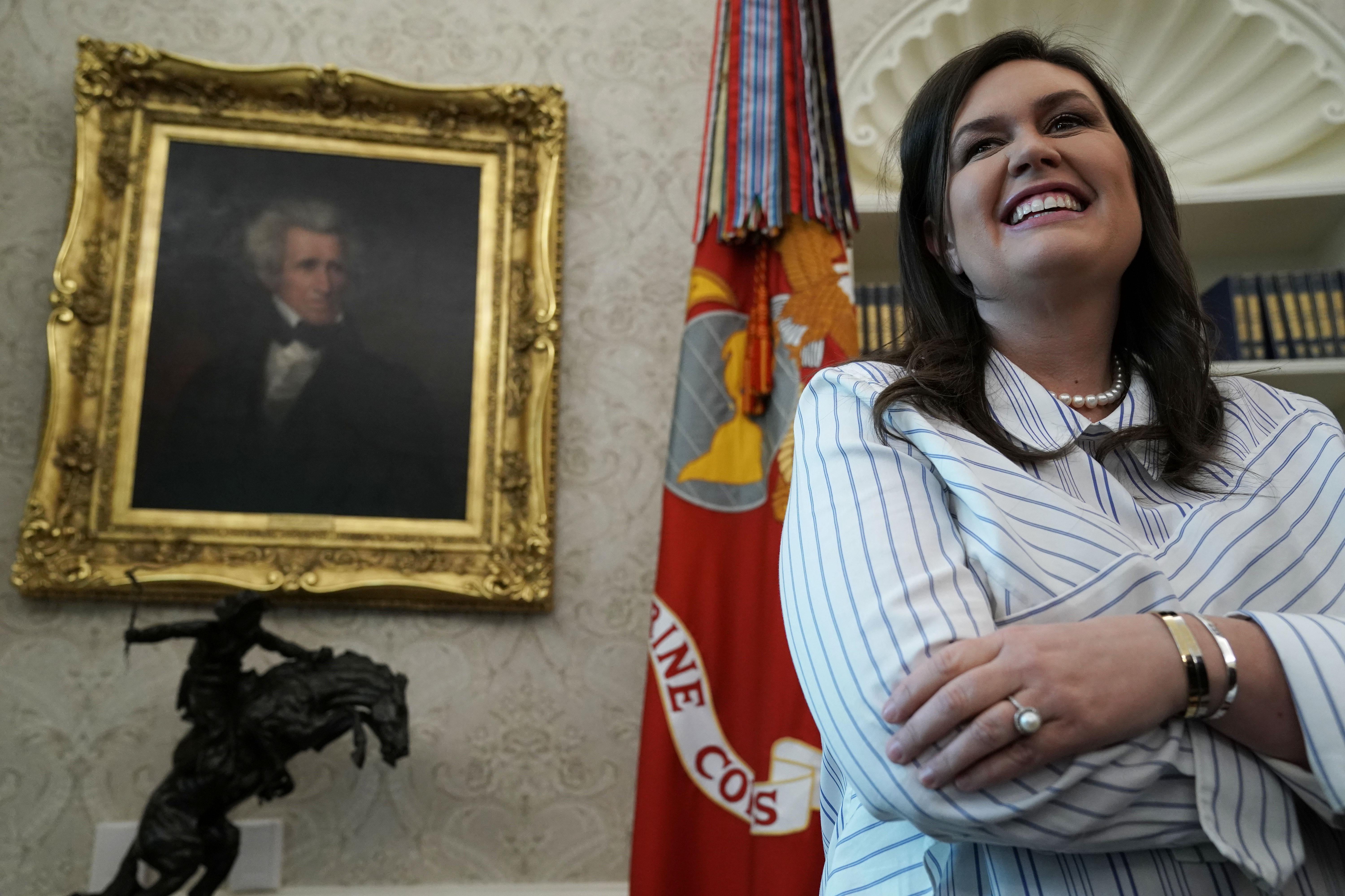 White House press secretary Sarah Sanders listens as President Donald Trump meets with World War II veterans in the Oval Office of the White House April 11, 2019 in Washington, D.C. 