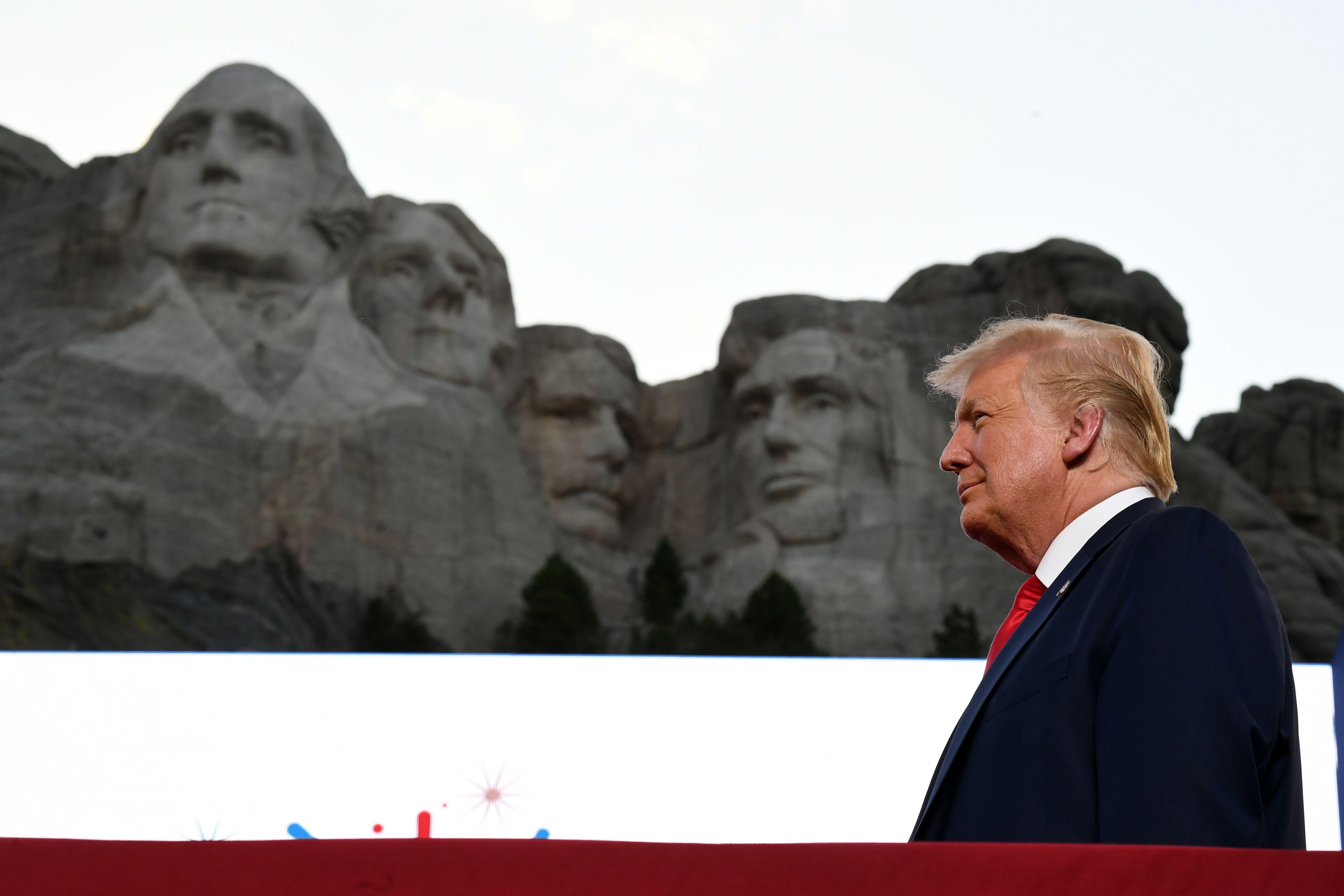 Trump is seen in front of Mount Rushmore.