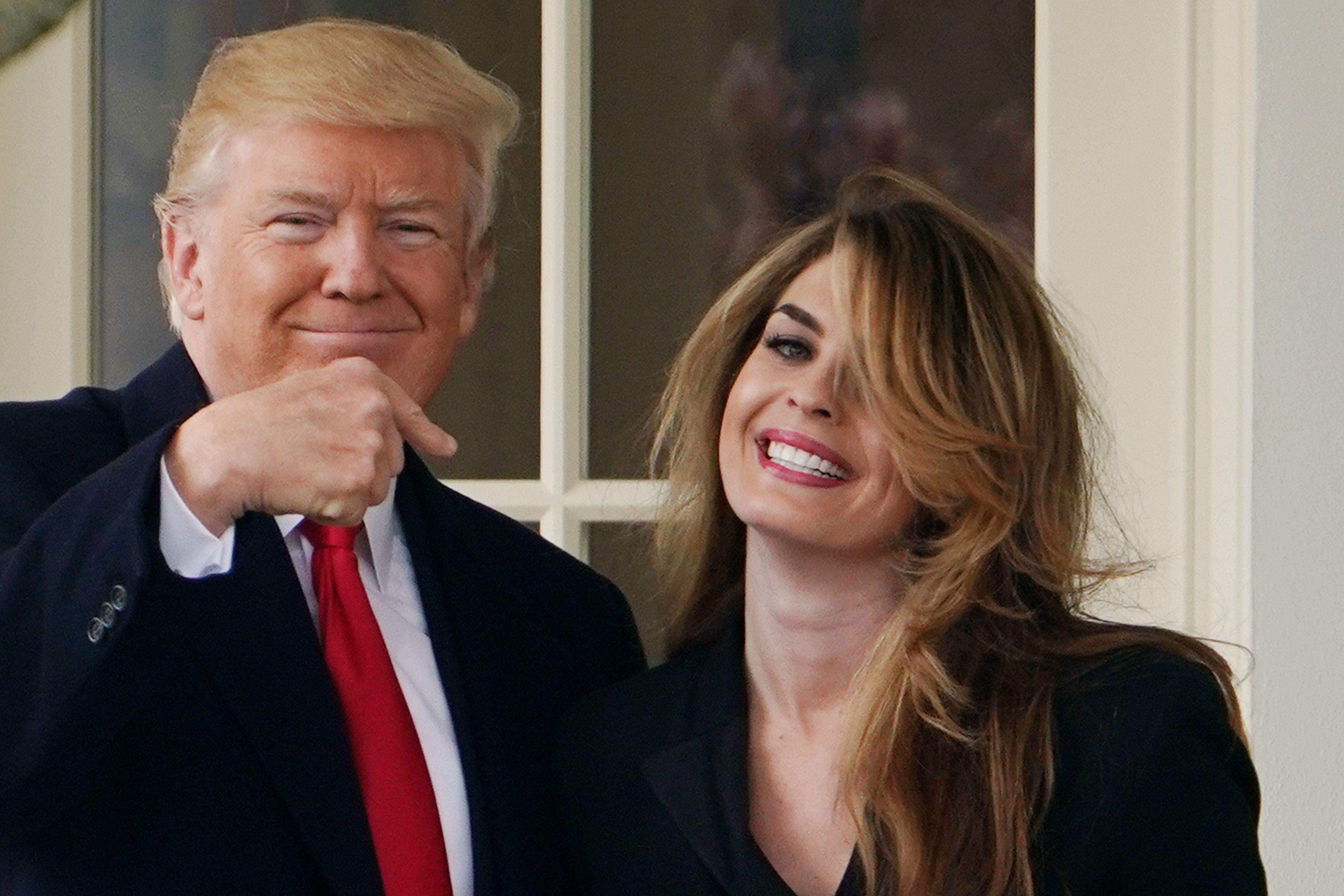 President Donald Trump points to former communications director Hope Hicks shortly before making his way to board Marine One on the South Lawn and departing from the White House on March 29, 2018.