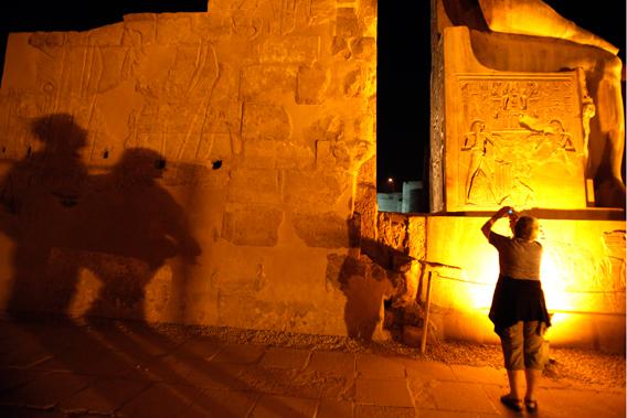 Tourists take pictures as they walk inside the Luxor Temple in Luxor city, around 650 km (404 miles) south of Cairo, December 4, 2010.