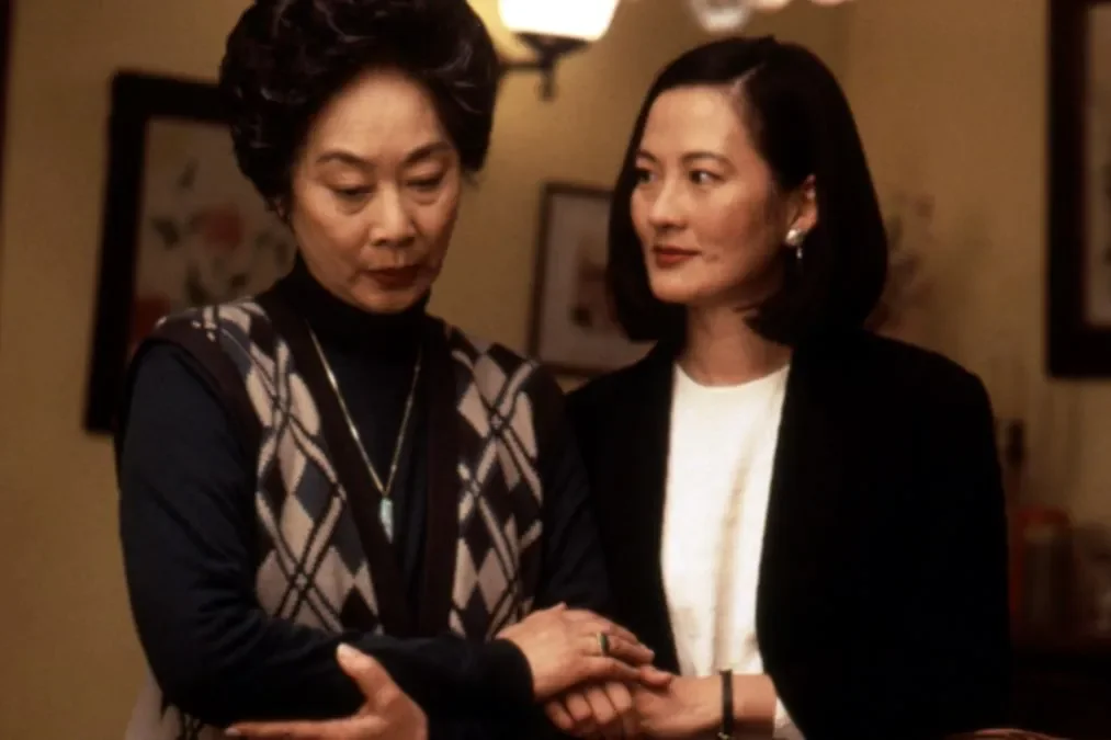 Rosalind Chao reassuringly holds the hand of Lisa Lu who looks down.