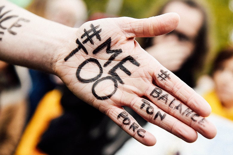 A protestor shows the messages #MeToo and #BalanceTonPorc.