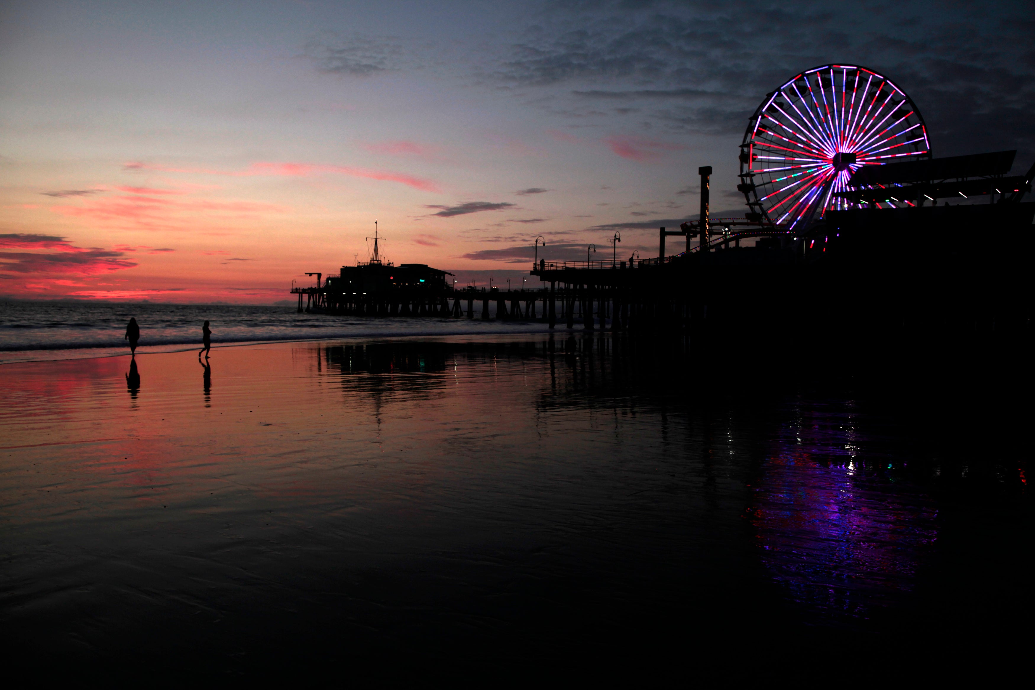 The Santa Monica pier seen in silhouette.