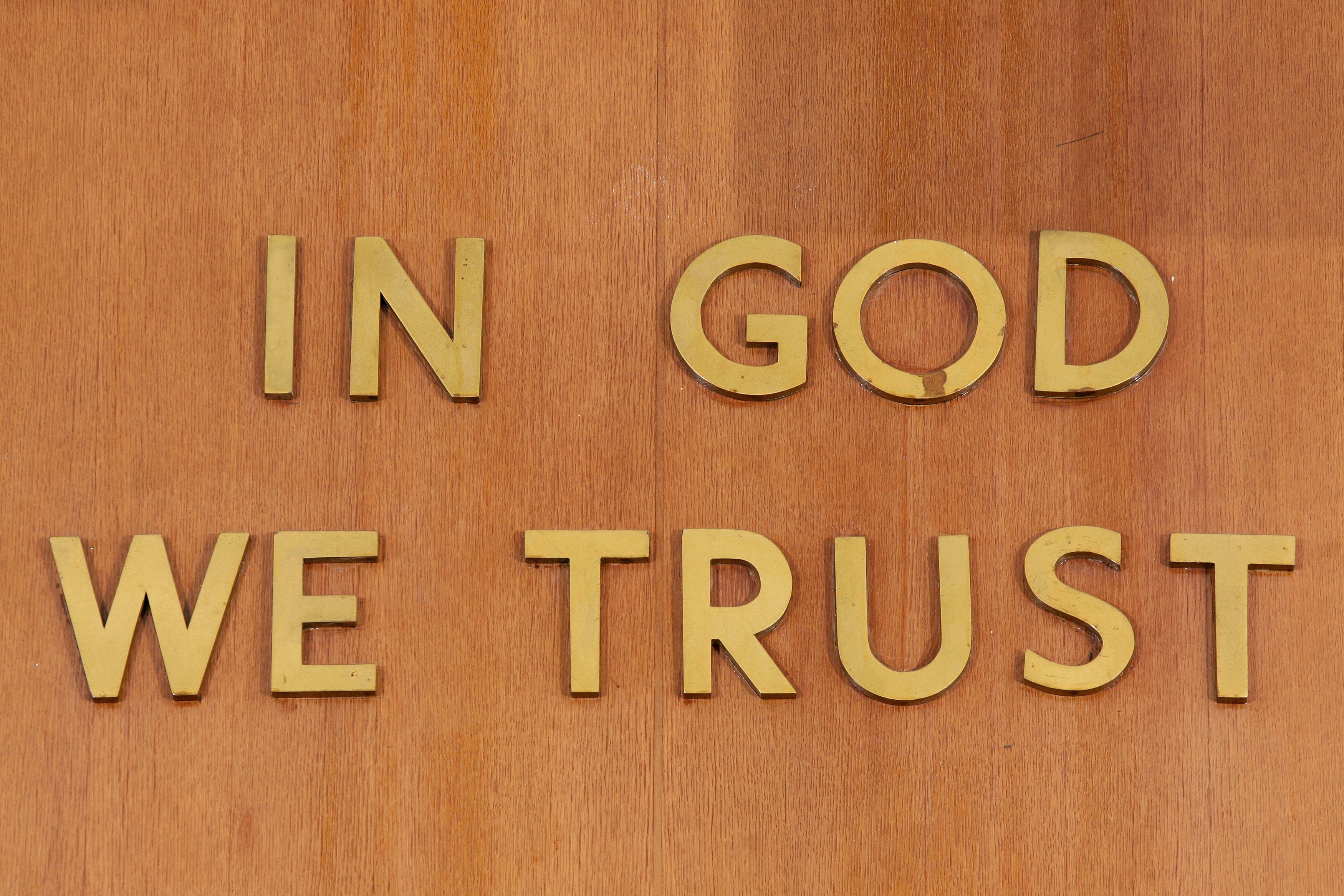 "In God We Trust" is inscribed above the judge's chair at the New York State Supreme Court.
