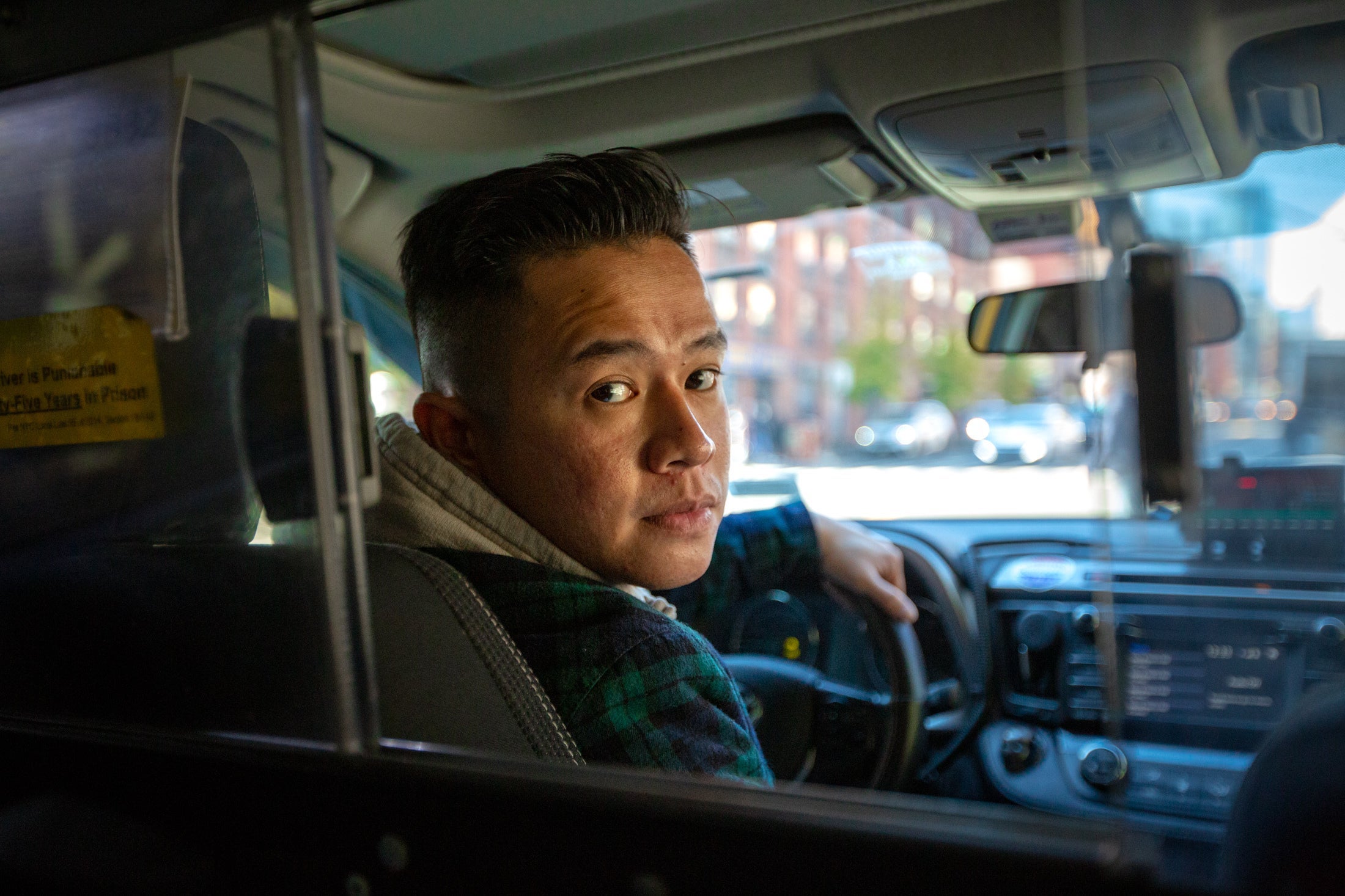 Augustine Tang in his cab.
