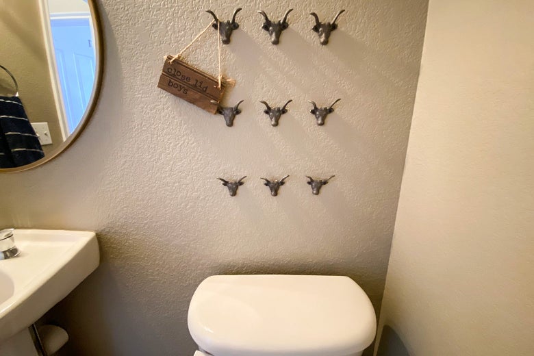 There's a cute wooden sign that's hanging above the toilet that reads 'close lid boys.'