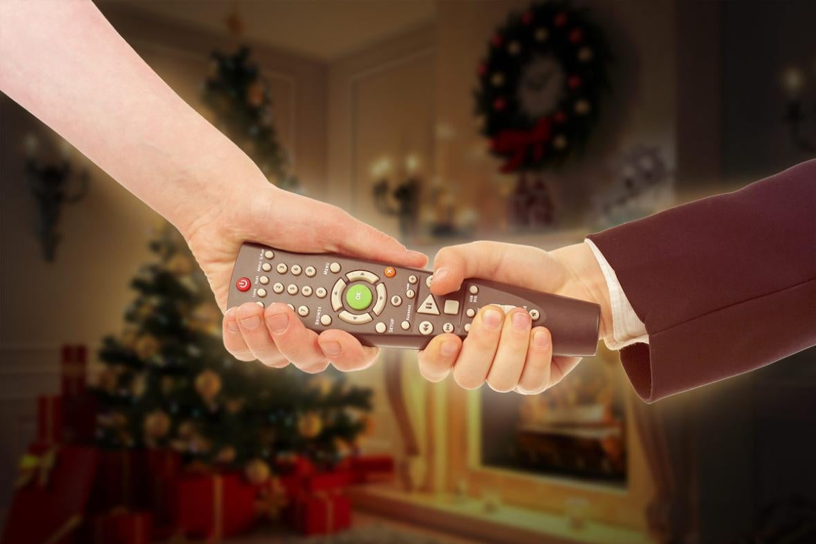 A man and a woman both tug at a remote control.