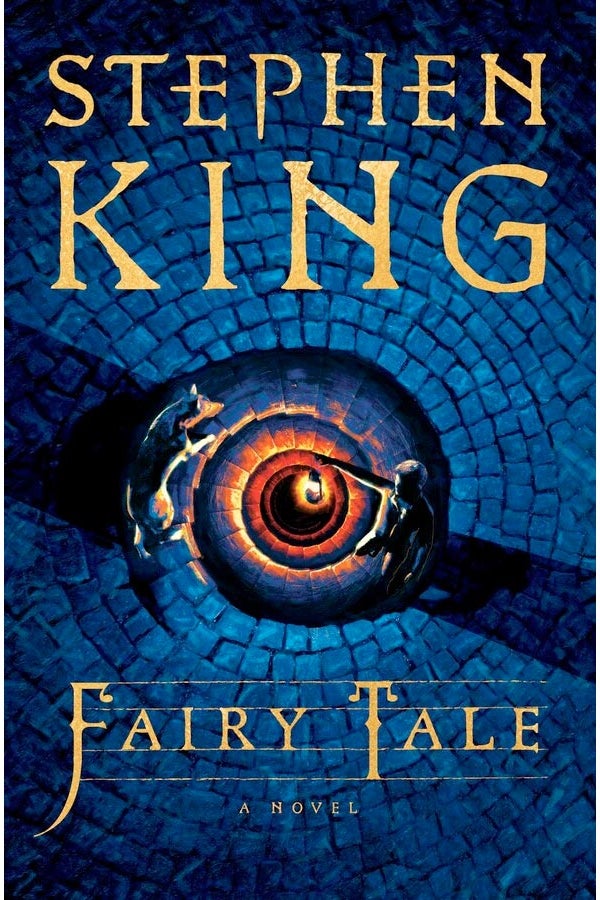 The cover of Fairy Tale looks down from above into a stone staircase leading downward in a long spiral, a boy's lantern lighting the way on a blue night, and his dog lit by the fiery glow and walking down with him.