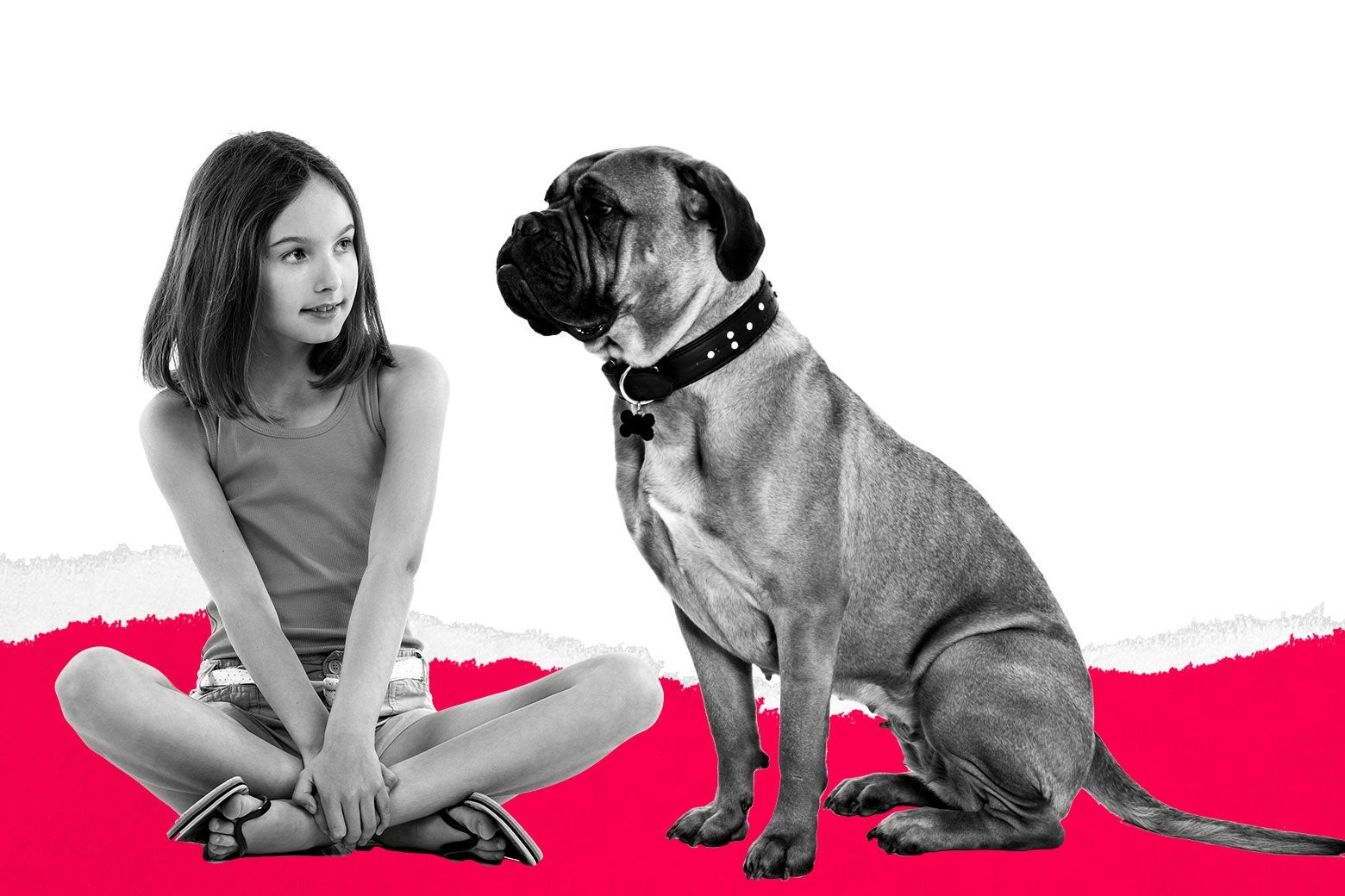 A girl sitting cross-legged next to a dog.