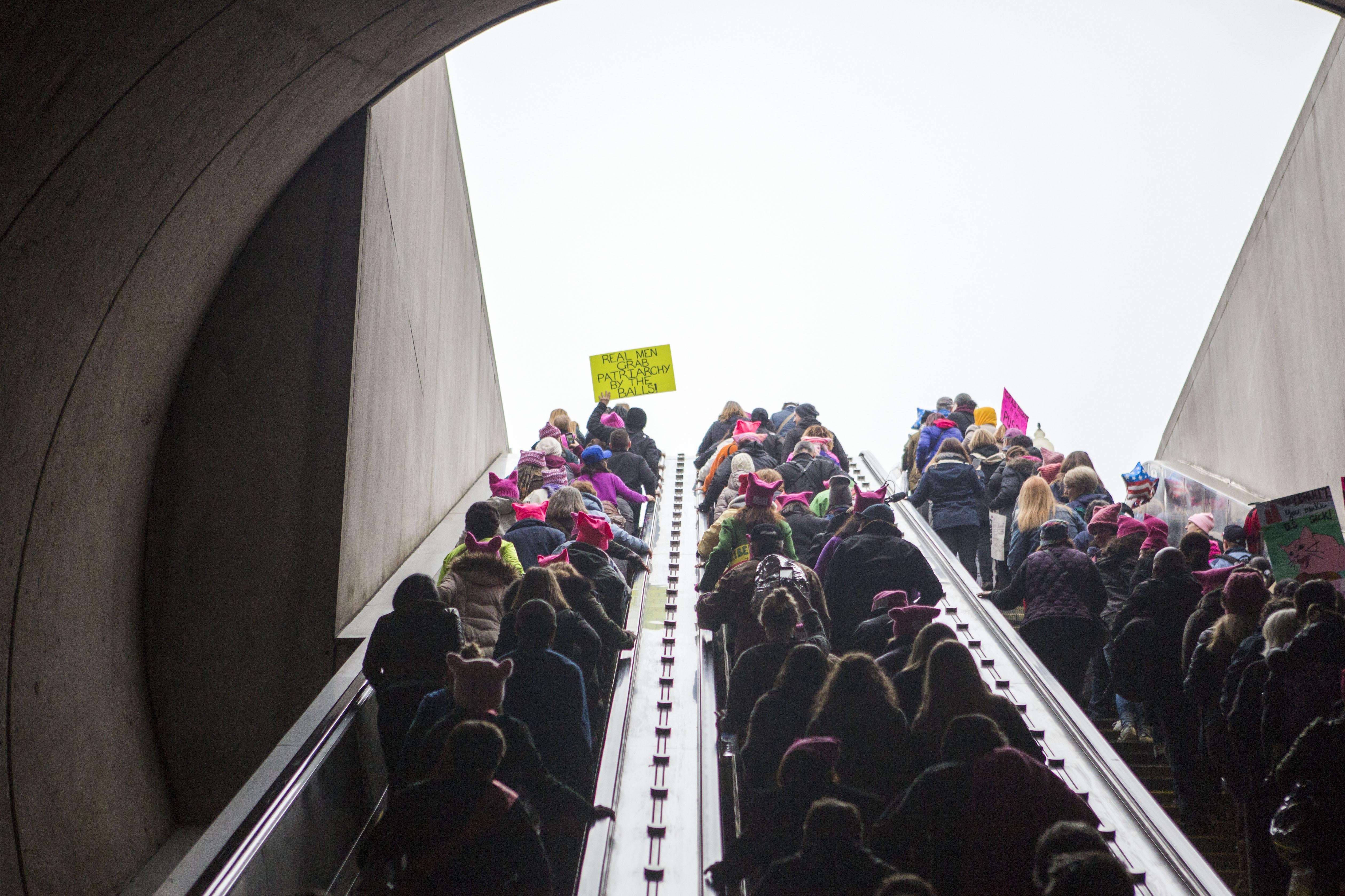 A crowd of protesters take the escalator up from a Washington DC metro station to join the Women's March on January 21, 2017.