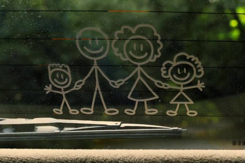 A still from Us depicting a car rear-window decal of a stick-figure family of four people,