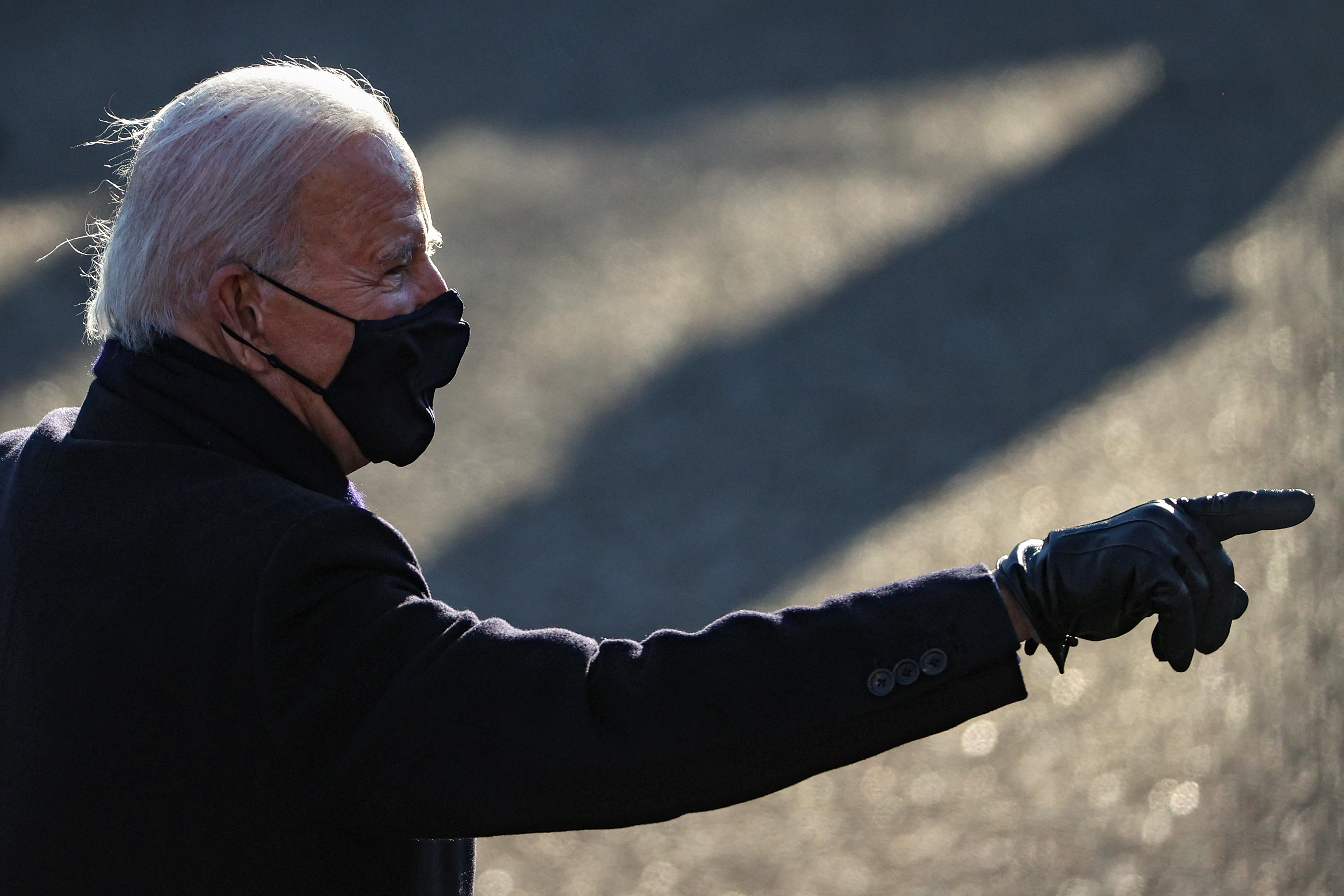Biden energetically points at the crowd as he walks to the White House after the inauguration.