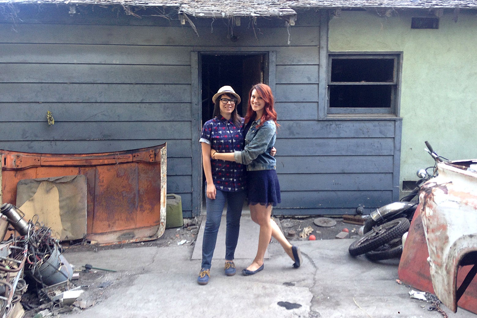 Aubree Bernier-Clarke and Jordan Strang in front of their burned-down shack.