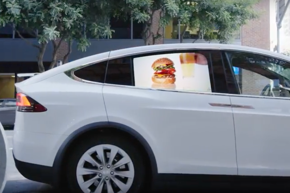A Grabb-It ad in a car window.
