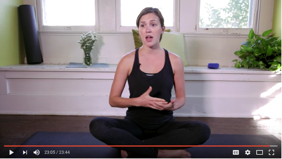 Screen capture from YouTube of a woman doing yoga.