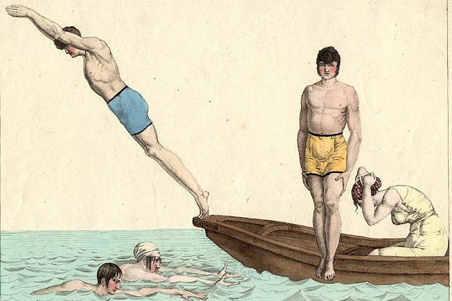 A group of swimmers diving in and swimming.