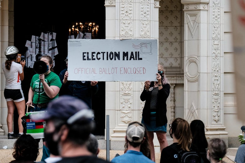 Demonstrators gather outside of the condo of President Donald Trump donor and current U.S. Postmaster General Louis Dejoy on August 15, 2020 in Washington, D.C.