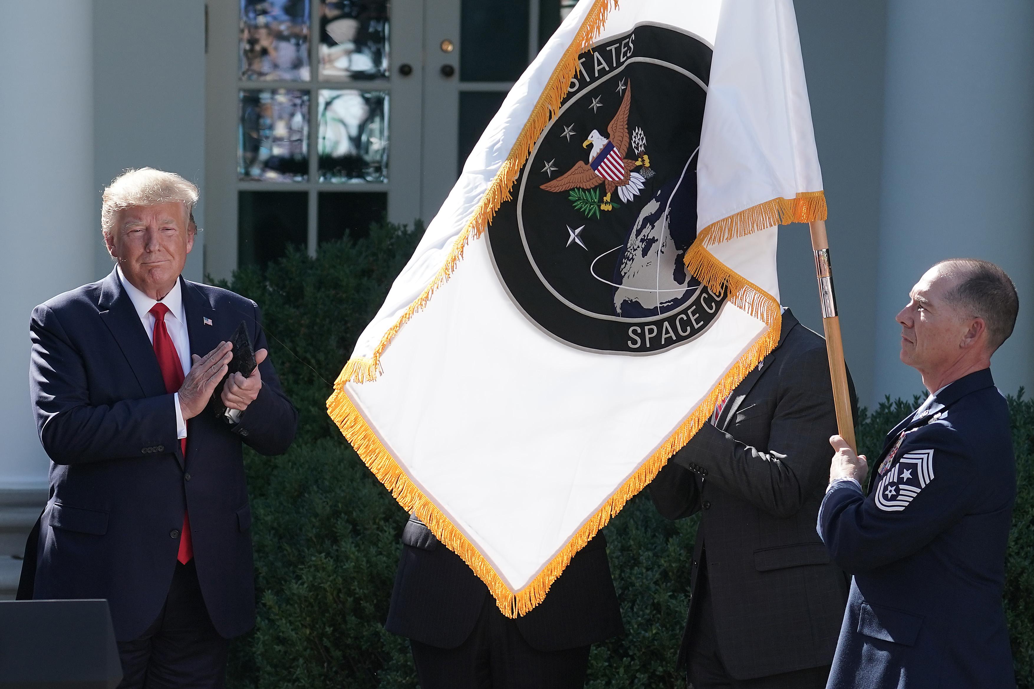 President Donald Trump applauds as the flag for the new U.S. Space Command is revealed in the Rose Garden at the White House August 29, 2019 in Washington, D.C. 