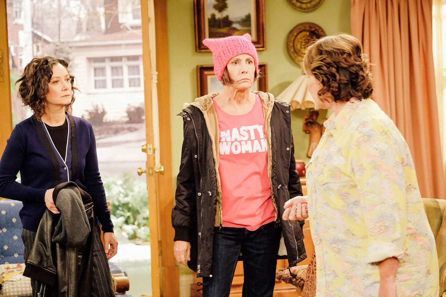 Sara Gilbert, Laurie Metcalf, and Roseanne Barr in a scene from Roseanne.