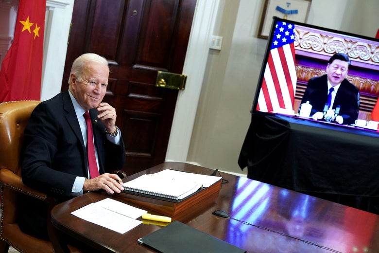 US President Joe Biden sits at a desk while talking to China's President Xi Jinping on a screen during a virtual summit from the Roosevelt Room of the White House in Washington, DC, November 15, 2021. 
