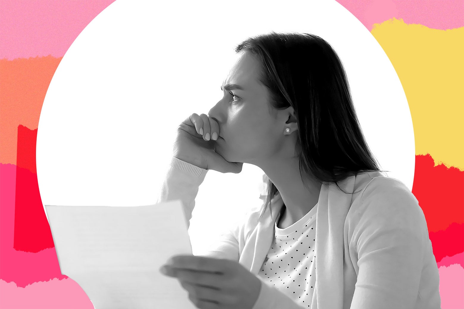 A woman looks worried holding a piece of paper.