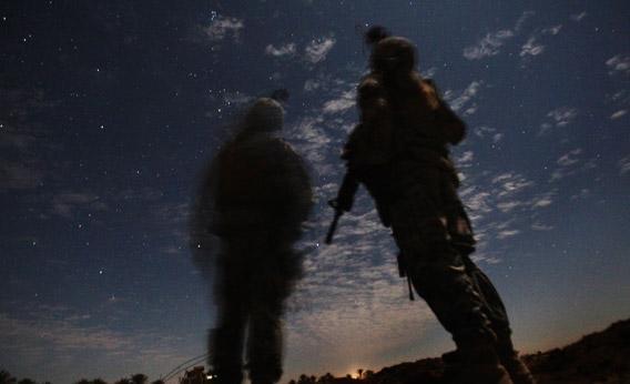 U.S. Army soldiers from Charlie Company 2-5 Cavalry Regiment watch for illumination rounds during a night patrol near Camp Kalsu in Tunis, Iraq, 20 miles south of Baghdad on December 5, 2011.