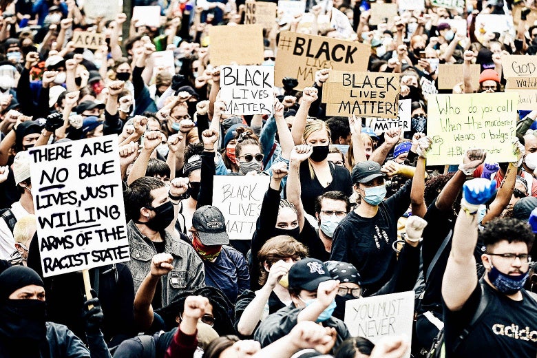 A crowd of protesters holding up Black Lives Matter signs