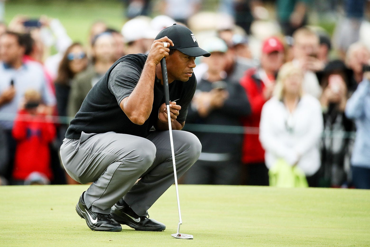 Tiger Woods lines up a putt on the 10th green during the third round of the BMW Championship.