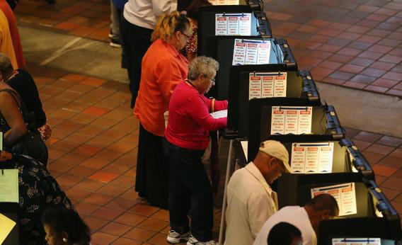 Early voters fill out their ballots in Miami, Florida as they cast their vote in the presidential election on the first day of early voting on Saturday.