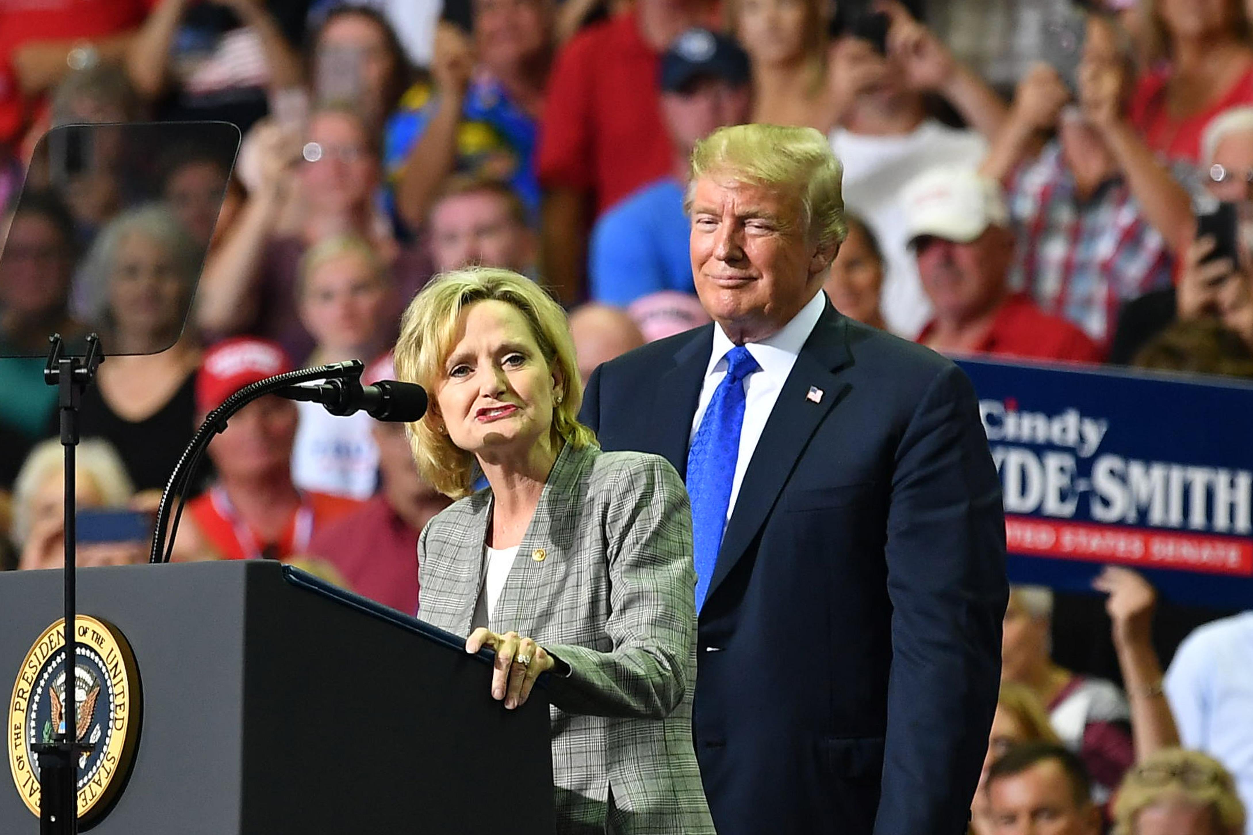 Senator Cindy Hyde-Smith stands on stage with President Donald Trump at Landers Center in Southaven, Mississippi, on October 2, 2018.